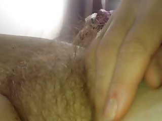 see how my wife enjoys stroking her own hairy pussy